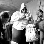 A lady swopping tokens for goods in the Recycle Swop Shop