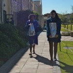 Student helping to carrying food parcels